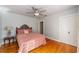 Bedroom with wood floors, ceiling fan, and a doorway visible at 114 Ne 11Th Ave, Ocala, FL 34470
