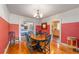 Classic dining room showcases hardwood floors, wainscoting, and a view into the nearby bedroom, and a side entrance at 114 Ne 11Th Ave, Ocala, FL 34470