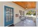 Close-up of front porch with seating area, flag and decorative door at 114 Ne 11Th Ave, Ocala, FL 34470