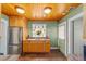 Bright kitchen with wood cabinets, stainless steel refrigerator, and stone floors at 114 Ne 11Th Ave, Ocala, FL 34470