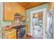 Kitchen with wooden cabinets and granite countertops, offering a view to the sunroom at 114 Ne 11Th Ave, Ocala, FL 34470
