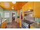 Charming kitchen featuring wood cabinets, granite countertops, and stone flooring at 114 Ne 11Th Ave, Ocala, FL 34470