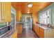 Charming kitchen with wooden ceiling, stainless steel appliances, granite counters, and a view of the dining area at 114 Ne 11Th Ave, Ocala, FL 34470