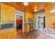 The kitchen features wooden cabinets, tile floors, stainless steel appliances, and a view into the adjacent dining room at 114 Ne 11Th Ave, Ocala, FL 34470