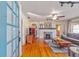 Inviting living room with hardwood floors, fireplace, ceiling fan and natural light streaming in from the front windows at 114 Ne 11Th Ave, Ocala, FL 34470