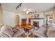 Spacious living room with hardwood floors, cozy seating, fireplace, and large windows providing plenty of natural light at 114 Ne 11Th Ave, Ocala, FL 34470
