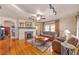 Cozy living room boasts hardwood floors, a classic fireplace, and comfortable seating, illuminated by modern track lighting at 114 Ne 11Th Ave, Ocala, FL 34470