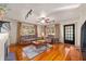 Bright living room with hardwood floors, fireplace, track lights, large windows, comfortable seating, and a stylish rug at 114 Ne 11Th Ave, Ocala, FL 34470