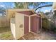Exterior view of a storage shed with two doors and outdoor lighting at 114 Ne 11Th Ave, Ocala, FL 34470