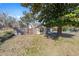 Landscaped yard with a large tree providing shade and a fenced border at 114 Ne 11Th Ave, Ocala, FL 34470