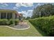Private backyard featuring a patio area, manicured lawn, and neatly trimmed hedges for added seclusion at 13170 Se 92Nd Court Rd, Summerfield, FL 34491