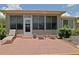 Relaxing outdoor patio with seating, complemented by a screened lanai for year-round enjoyment at 13170 Se 92Nd Court Rd, Summerfield, FL 34491