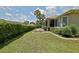 Private backyard with lush greenery, manicured lawn, screened lanai, and patio area for entertaining at 13170 Se 92Nd Court Rd, Summerfield, FL 34491