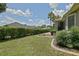 Peaceful backyard showcases manicured landscaping, a private hedge, and a screened-in patio at 13170 Se 92Nd Court Rd, Summerfield, FL 34491