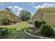 Beautifully landscaped backyard with manicured lawn and decorative flowerbeds between two homes at 13170 Se 92Nd Court Rd, Summerfield, FL 34491