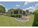 Enjoyable backyard with screened lanai, patio, well-kept lawn, and attractive landscaping features at 13170 Se 92Nd Court Rd, Summerfield, FL 34491