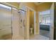 Bathroom with an updated glass shower, toilet and doorway access to bedroom with natural light at 13170 Se 92Nd Court Rd, Summerfield, FL 34491