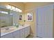 Bathroom featuring a double sink vanity, ample lighting, and a glass enclosed shower at 13170 Se 92Nd Court Rd, Summerfield, FL 34491