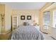 Cozy bedroom with a plush bed, built-in shelving, and a sunny window, creating a relaxing retreat at 13170 Se 92Nd Court Rd, Summerfield, FL 34491