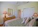 Bedroom featuring a comfortable bed, a closet, and ample natural light streaming through the windows at 13170 Se 92Nd Court Rd, Summerfield, FL 34491