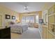 Bright bedroom featuring a ceiling fan, desk, and dresser, offering a comfortable and stylish space at 13170 Se 92Nd Court Rd, Summerfield, FL 34491