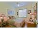 Serene bedroom with a ceiling fan, a comfortable bed and a view from the window at 13170 Se 92Nd Court Rd, Summerfield, FL 34491