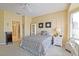 Well-lit bedroom with en-suite access, featuring a view of the bathroom and ample closet space at 13170 Se 92Nd Court Rd, Summerfield, FL 34491
