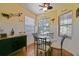 Cozy breakfast nook with decorative wall art, plenty of natural light from windows and a modern ceiling fan at 13170 Se 92Nd Court Rd, Summerfield, FL 34491