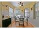 Charming breakfast nook with a glass table and comfortable chairs illuminated by a modern ceiling fan at 13170 Se 92Nd Court Rd, Summerfield, FL 34491