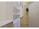 Bright walk-in closet with extensive shelving and storage solutions at 13170 Se 92Nd Court Rd, Summerfield, FL 34491