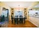 Open dining room with a sleek black table and views of the kitchen and outdoor patio at 13170 Se 92Nd Court Rd, Summerfield, FL 34491