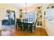 Open dining room with a sleek black table and views of the outdoor patio at 13170 Se 92Nd Court Rd, Summerfield, FL 34491