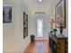 Elegant foyer with hardwood floors, decorative accents, and a stylish glass front door at 13170 Se 92Nd Court Rd, Summerfield, FL 34491