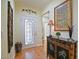 Bright and inviting foyer with hardwood flooring, tasteful decor, and a clear view of the front door at 13170 Se 92Nd Court Rd, Summerfield, FL 34491