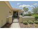 Welcoming front entrance featuring a secure metal gate, stone pathway, and professionally landscaped garden at 13170 Se 92Nd Court Rd, Summerfield, FL 34491
