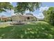 Well-maintained home with a lush lawn, mature trees, and a lovely landscaped garden in the front yard at 13170 Se 92Nd Court Rd, Summerfield, FL 34491