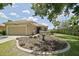 Charming home featuring a well-maintained lawn, mature landscaping, and an inviting front entrance at 13170 Se 92Nd Court Rd, Summerfield, FL 34491