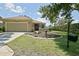 Inviting single-Gathering home with landscaped front yard, mature tree, and an attached two-car garage at 13170 Se 92Nd Court Rd, Summerfield, FL 34491
