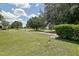 Scenic golf course view with lush green grass, mature trees, and a clear blue sky with fluffy white clouds at 13170 Se 92Nd Court Rd, Summerfield, FL 34491