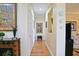 Hallway with wood floors and wall decor leading to other rooms in the home at 13170 Se 92Nd Court Rd, Summerfield, FL 34491