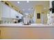 Open kitchen design with breakfast bar, modern appliances, and seamless flow into the breakfast nook and living spaces at 13170 Se 92Nd Court Rd, Summerfield, FL 34491