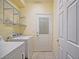 Functional laundry room with a washing machine, dryer, and storage shelves for an organized space at 13170 Se 92Nd Court Rd, Summerfield, FL 34491