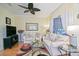 Cozy living room featuring neutral-toned sofas, modern decor, and a large flat screen TV for entertainment at 13170 Se 92Nd Court Rd, Summerfield, FL 34491