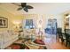 Inviting living room with comfortable sofas, a stylish rug, and seamless access to the outdoor patio at 13170 Se 92Nd Court Rd, Summerfield, FL 34491