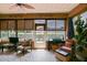 Relaxing sunroom with natural light, tile floors, and comfortable seating areas at 13170 Se 92Nd Court Rd, Summerfield, FL 34491