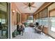 Inviting sunroom with tiled flooring, comfortable chairs, and plenty of natural light at 13170 Se 92Nd Court Rd, Summerfield, FL 34491