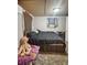 Bedroom featuring a comfortable bed, cozy rug, and climate control unit, ensuring year-round comfort at 15536 Se 203Rd Ave, Umatilla, FL 32784