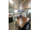 Classic kitchen featuring a dining table, laminate countertops, and essential appliances at 15536 Se 203Rd Ave, Umatilla, FL 32784