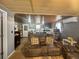 Cozy living room flowing into the kitchen with a comfortable reclining sofa and a unique ceiling at 15536 Se 203Rd Ave, Umatilla, FL 32784