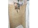 Shower featuring tiled walls, black and white tile floor, and shower rack at 15536 Se 203Rd Ave, Umatilla, FL 32784
